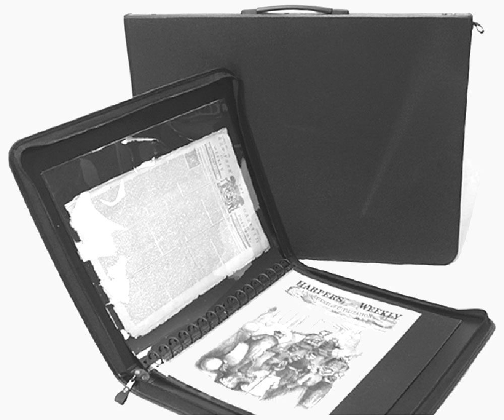 Presentation case opened with archival pages and a newspaper on display.